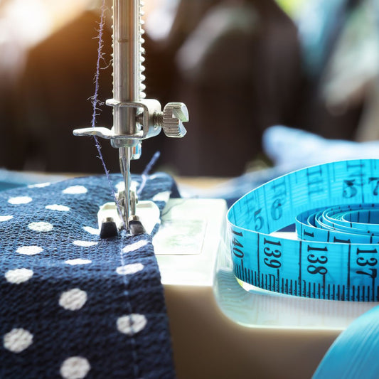 Machine foot with fabric and a blue tape measure